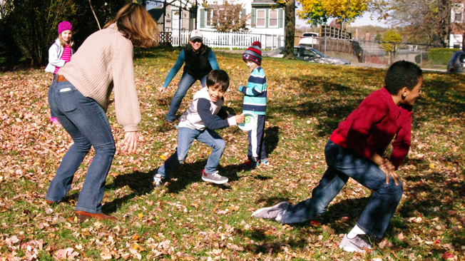Children and adults play tag