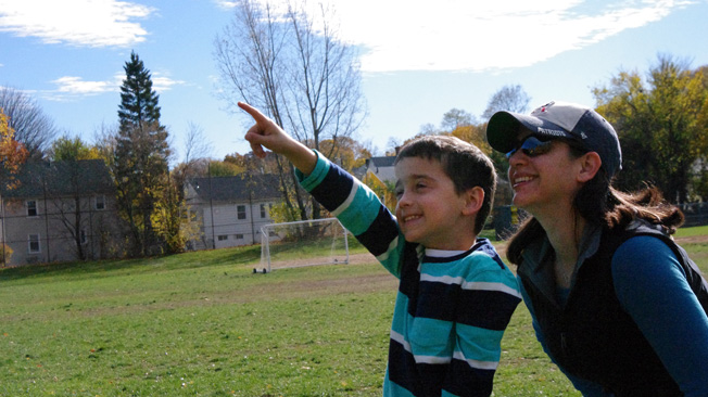 Parent with boy pointing to
sky