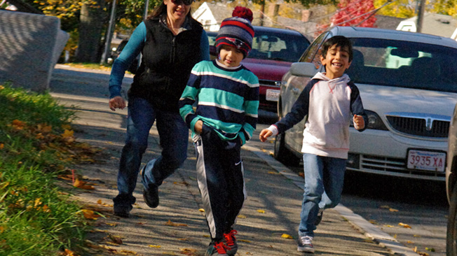 Two boys and parent running