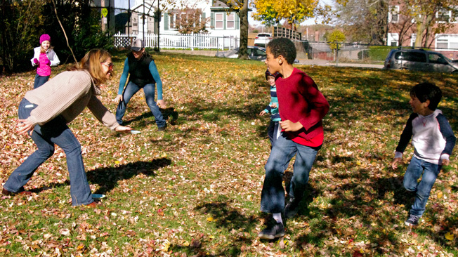 Kid and adults play tag